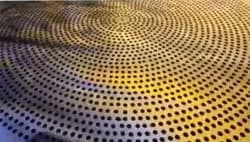 Close view of a perforated sevai jali plate with closely spaced drilled holes